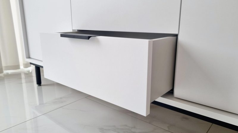 Moderne Kommode Cala, Nahaufnahme einer geöffneten Schublade mit schwarzem Griff